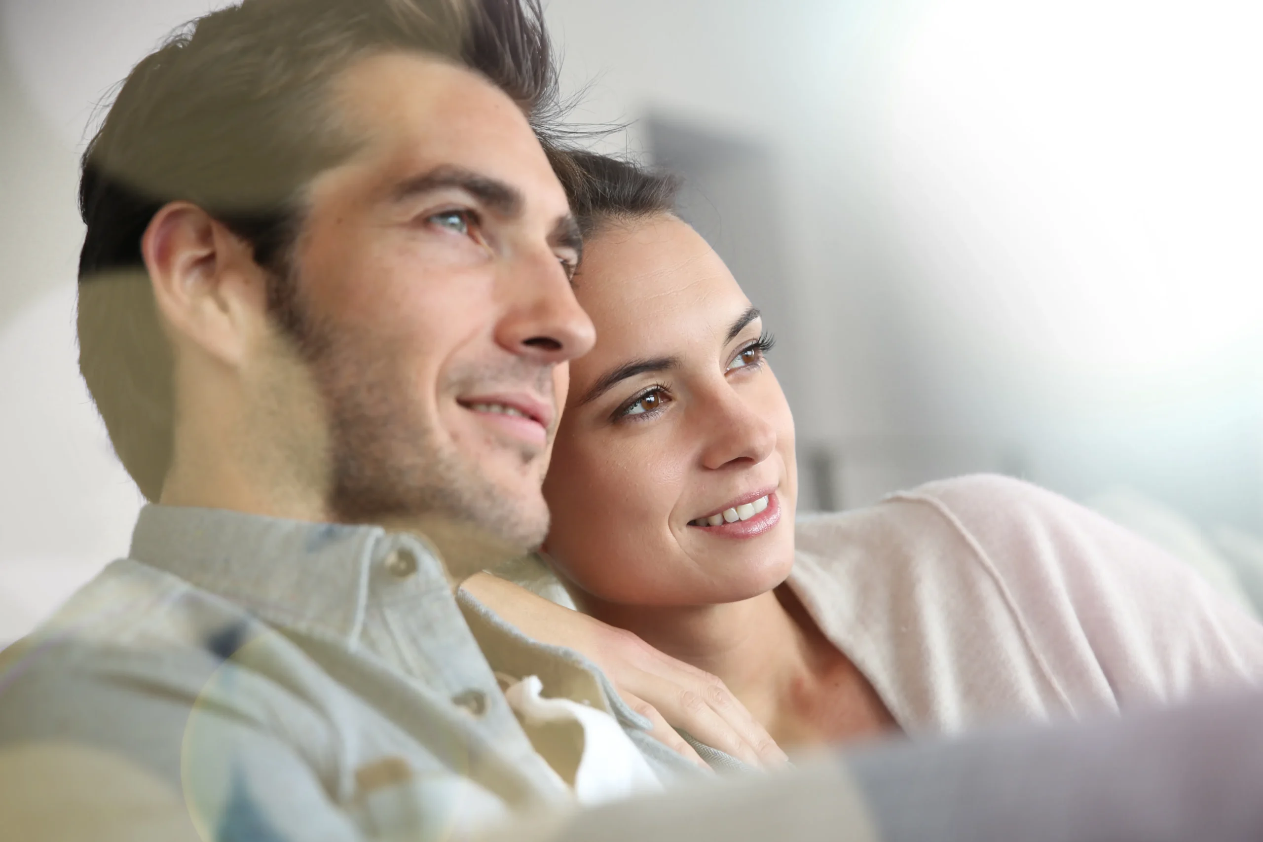 Bioidentical-Hormone-Replacement-Therapy-Clinic A smiling couple relaxes on their couch and looks out at the horizon. Get Bioidentical Hormone Replacement Therapy from Brandi Terra, NP at Oak & Stone Wellness in East San Diego.