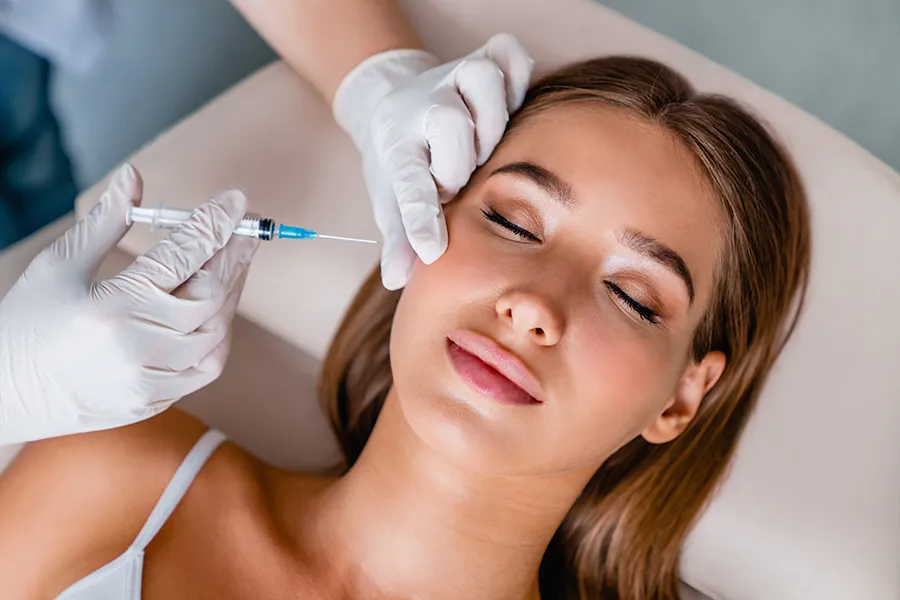 Dysport-Facial-Injections-Clinic A woman receiving facial injections. Get Dysport facial injections from Brandi Terra, NP at Oak & Stone Wellness in East San Diego.