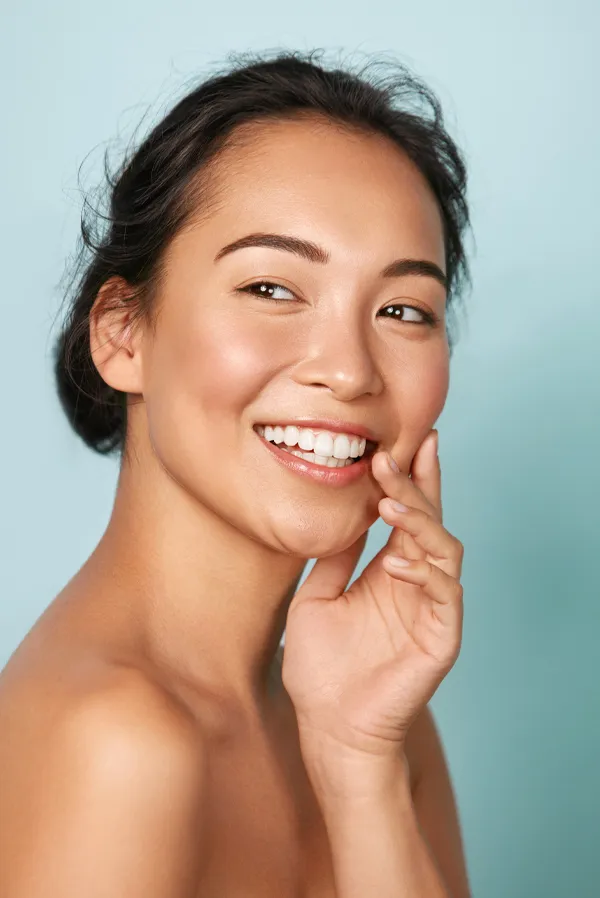 Dysport-Facial-Injections-Treatment An asian woman with radiant skin. Get Dysport facial injections from Brandi Terra, NP at Oak & Stone Wellness in East San Diego.