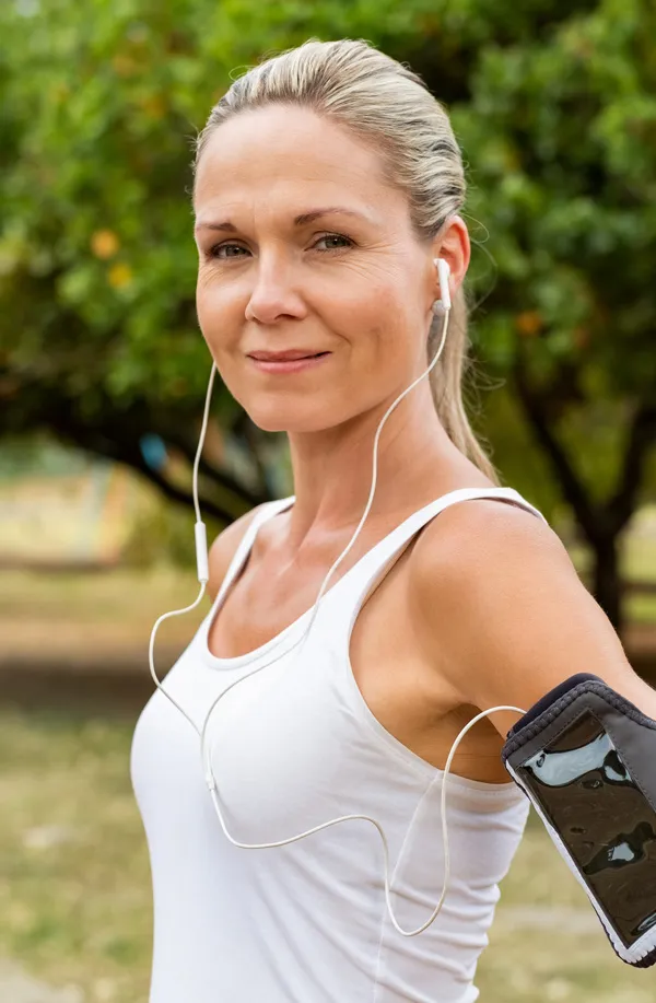 Evolve-Body-Contouring-Treatment A mature woman with smooth healthy skin prepares for a run. Get Evolve body contouring treatment from Brandi Terra, NP at Oak & Stone Wellness in East San Diego.