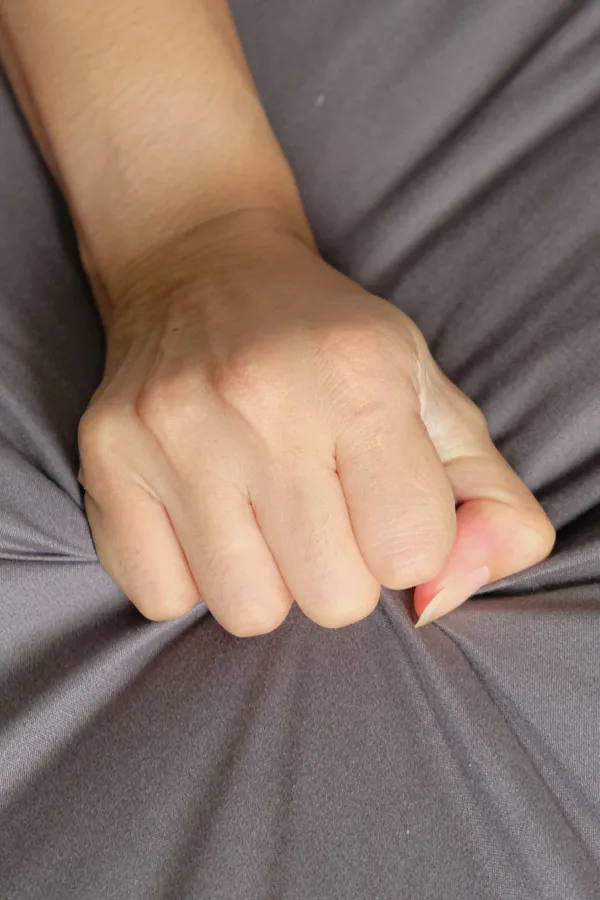 Female-Sexual-Dysfunction-Treatment Close-up of a woman's hand grabbing a sheet, indicating sexual pleasure. Get female sexual dysfunction treatment from Brandi Terra, NP at Oak & Stone Wellness in East San Diego.