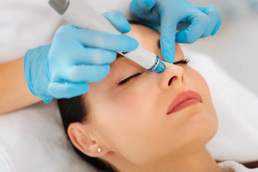 HydraFacial-Clinic A woman gets a hydrafacial treatment from Brandi Terra, NP at Oak & Stone Wellness in East San Diego.