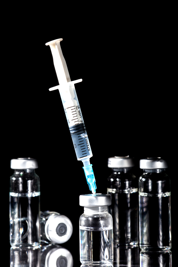 Jueveau-Facial-Injections-Treatment Close-up of a syringe and vials. Get Jueveau facial injections from Brandi Terra, NP at Oak & Stone Wellness in East San Diego.