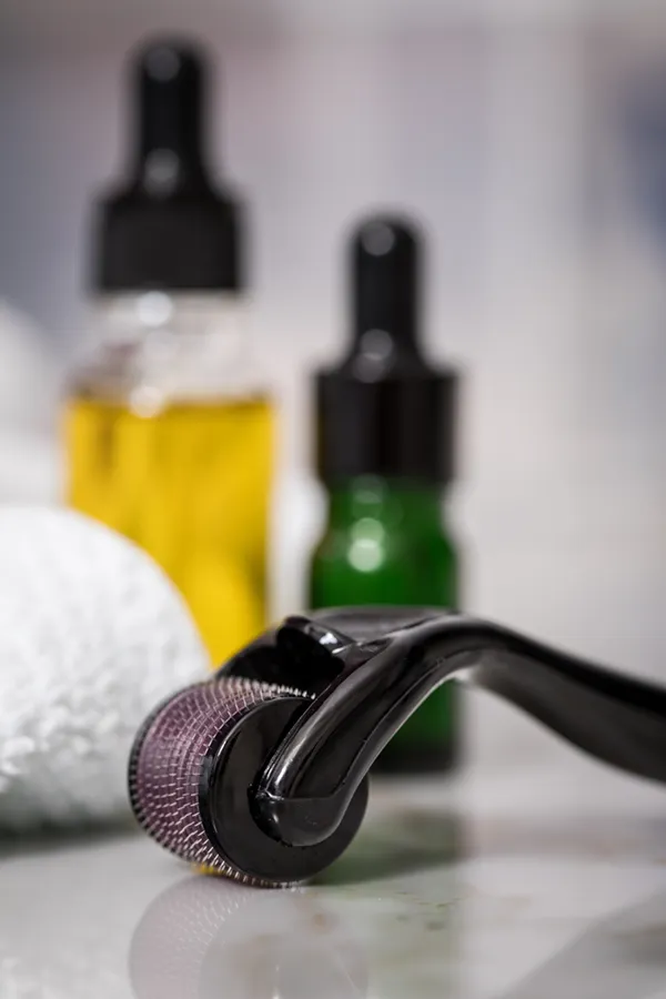 Microneedling-Treatment Close up of oils, a towel, and a microneedling tool used by Brandi Terra, NP at Oak & Stone Wellness in East San Diego.
