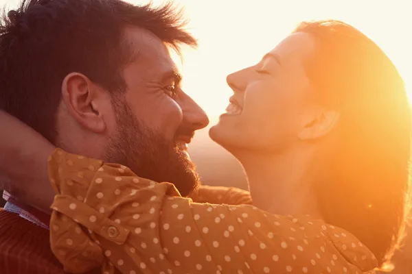 Ozone-IV-Therapy-Clinic A happy couple embracing, framed by the sunset. Schedule ozone IV therapy from Brandi Terra, NP at Oak & Stone Wellness in East San Diego.