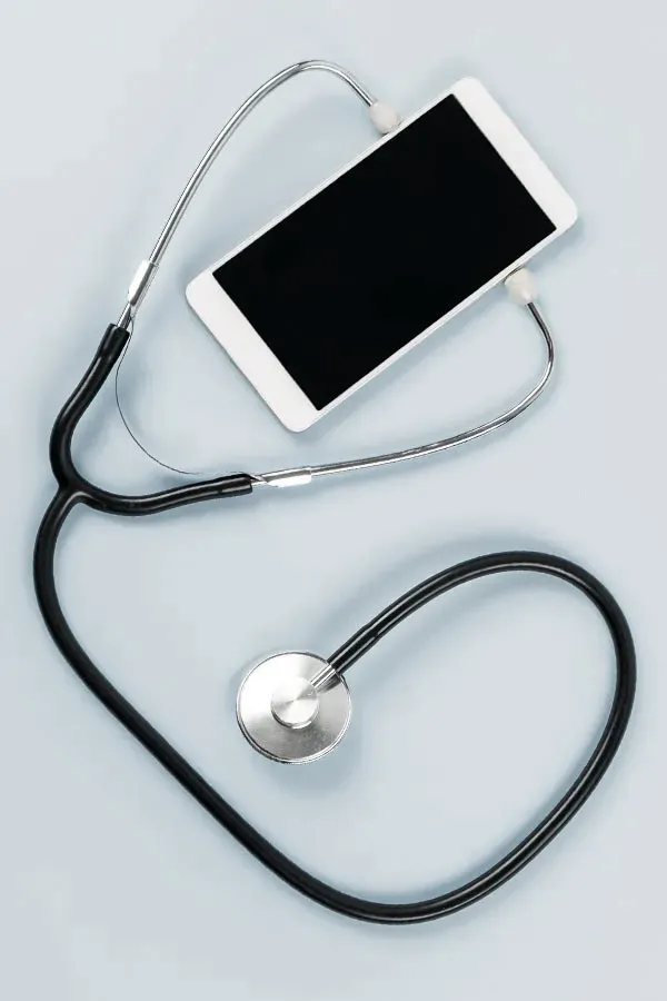 Telemedicine-Treatment A smartphone with a stethoscope attached to it, symbolizing Telemedicine treatment from Brandi Terra, NP at Oak & Stone Wellness in East San Diego.